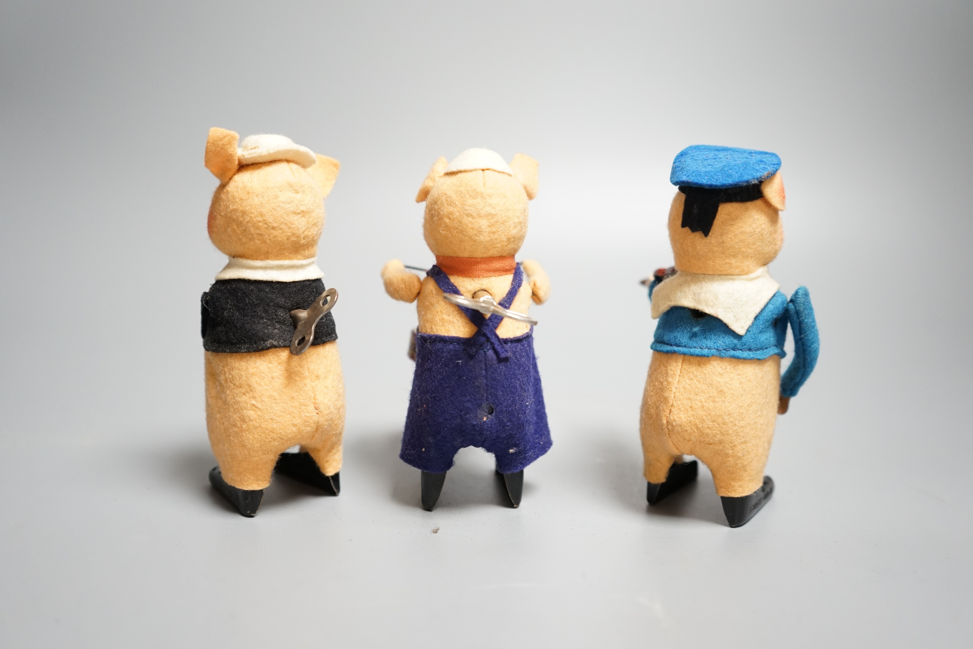 A set of three Schuco tinplate and felt clockwork pig musicians, pre war, tallest 11.5cm